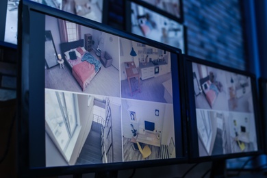 Photo of Modern monitors with video broadcasting from security cameras indoors. Safeguard's workplace
