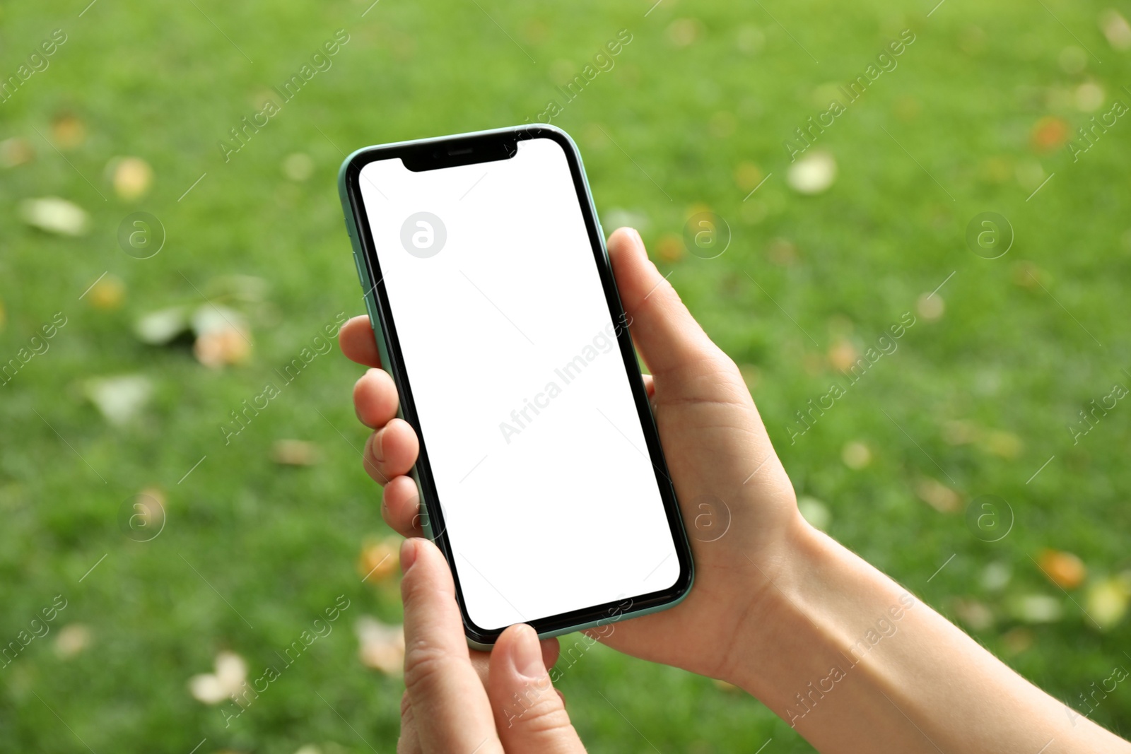 Photo of MYKOLAIV, UKRAINE - JULY 8, 2020: Woman holding Iphone 11 Pro Max with blank screen outdoors, closeup