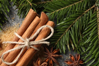 Photo of Different spices and fir branches on table, flat lay