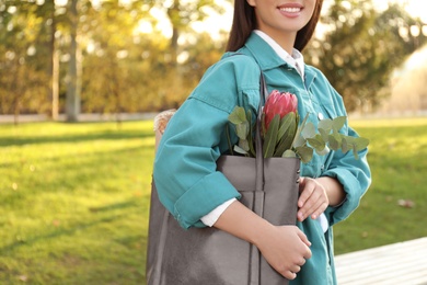 Photo of Woman with leather shopper bag in park, closeup