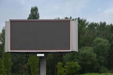 Photo of Blank advertising board outdoors. Mockup for design