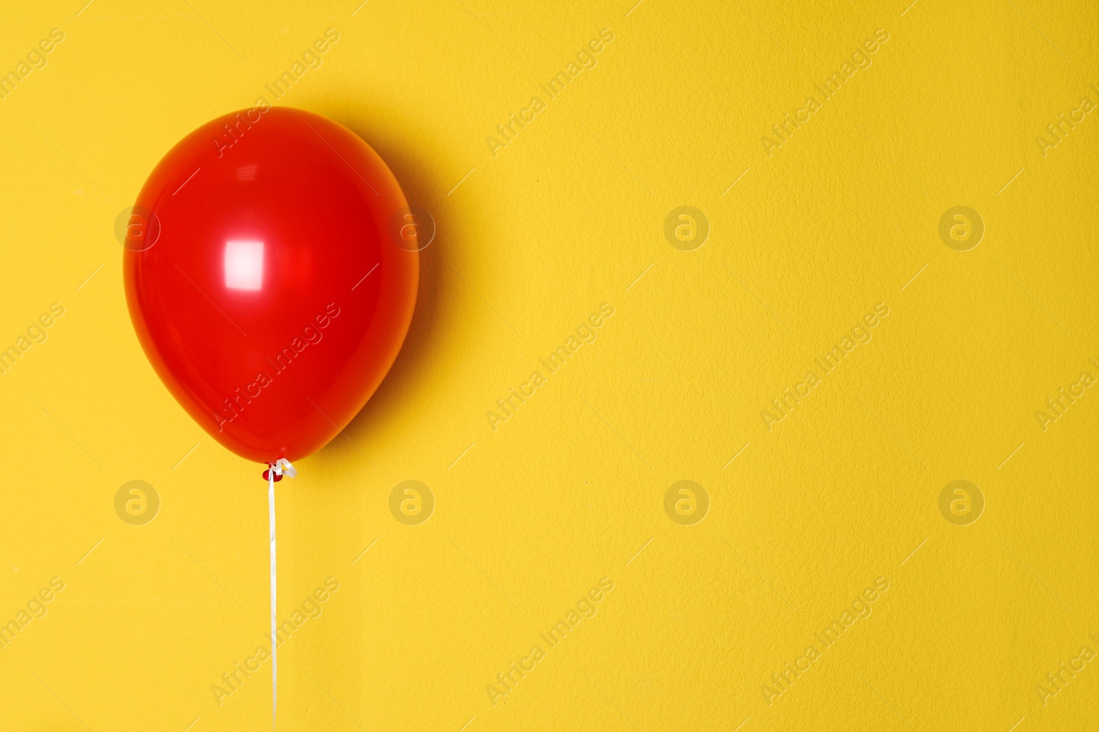 Photo of Red balloon on color background. Celebration time