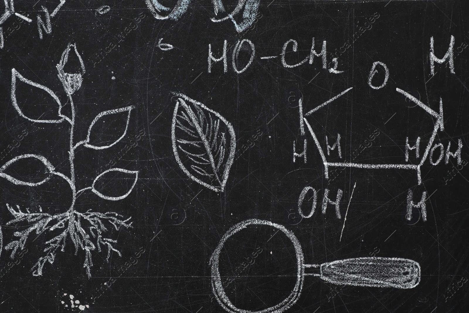 Photo of Chemical formulas and different pictures drawn on blackboard