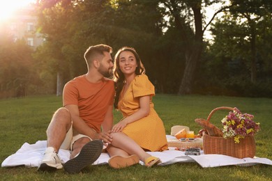 Photo of Lovely couple having picnic in park on sunny day
