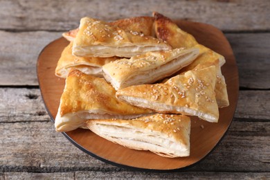 Photo of Delicious puff pastry on wooden table, closeup