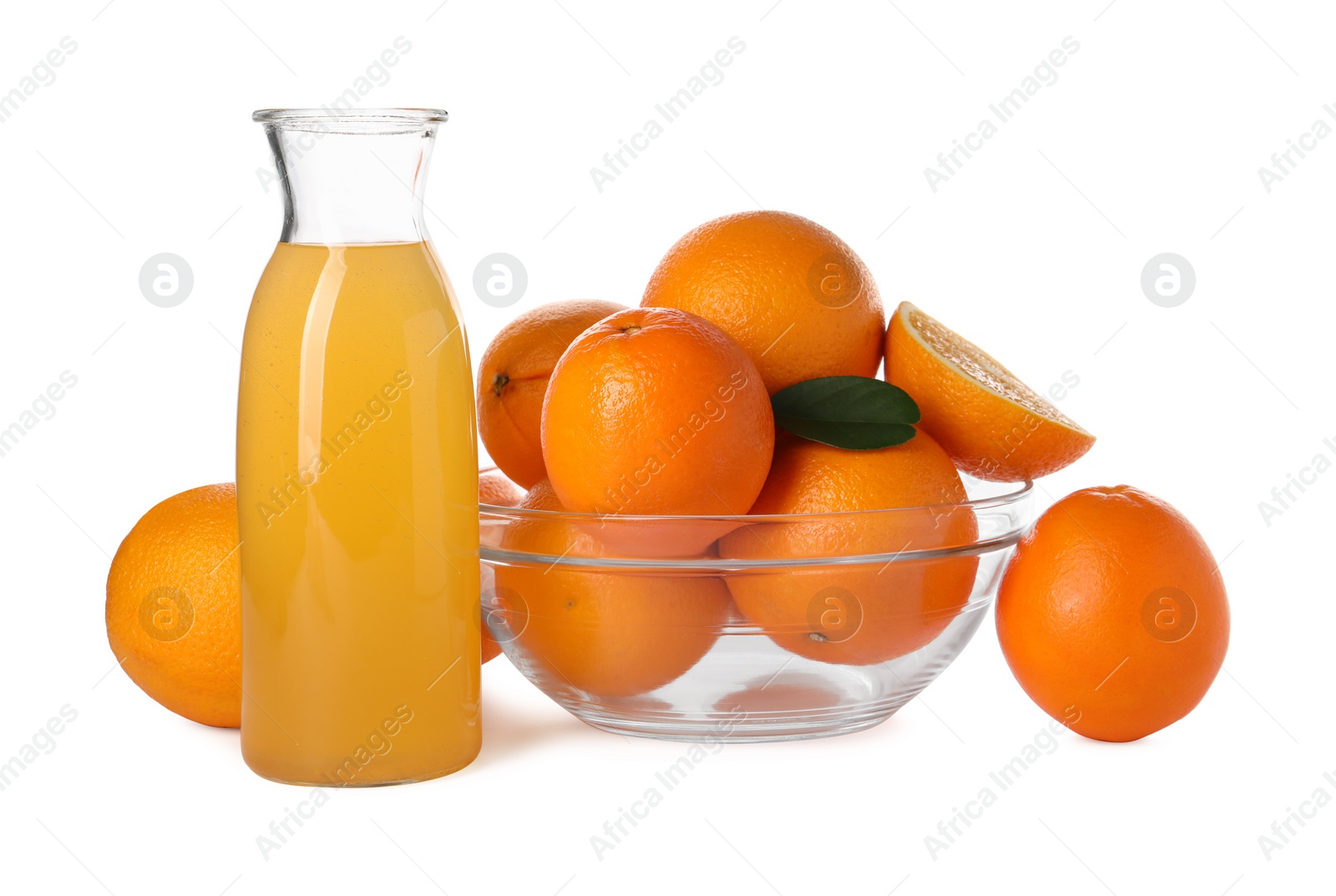 Photo of Fresh oranges in bowl and bottle of juice isolated on white