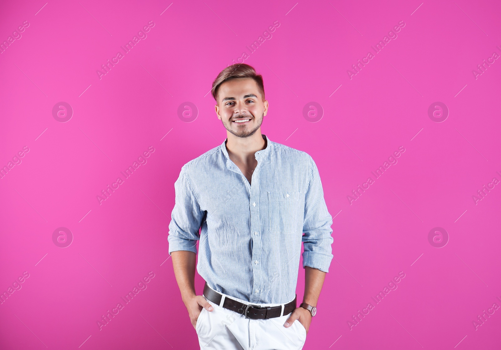 Photo of Young man with trendy hairstyle on color background