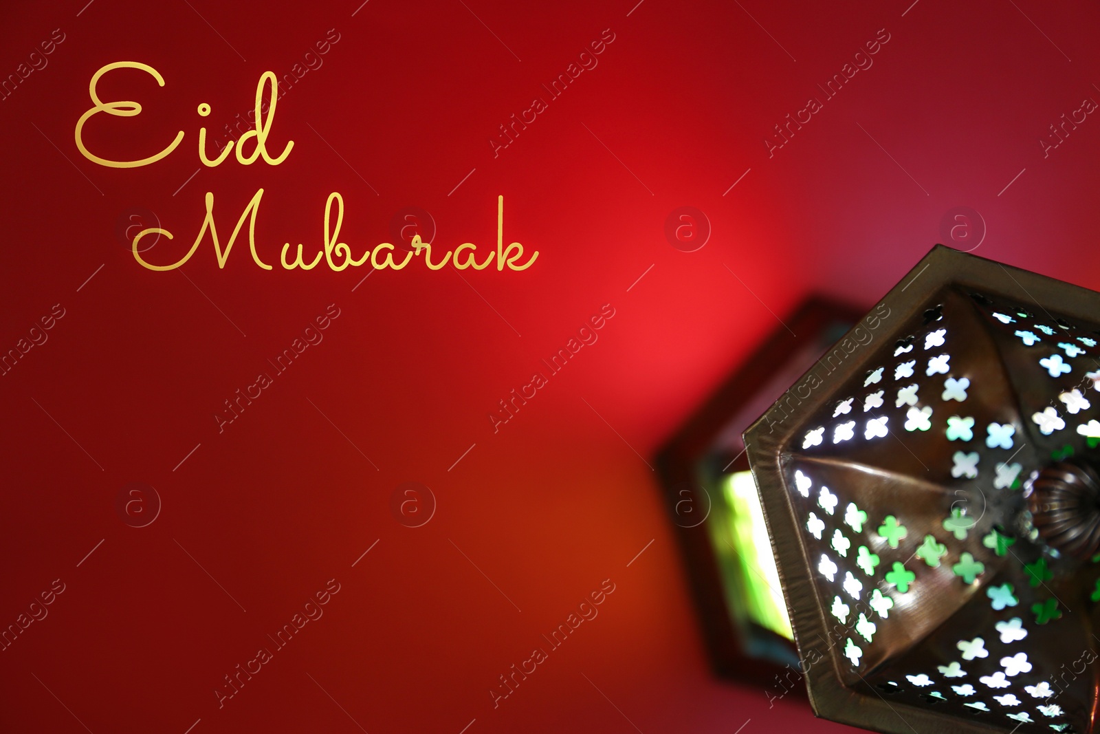 Image of Eid Mubarak greeting card. Arabic lantern on red background, top view