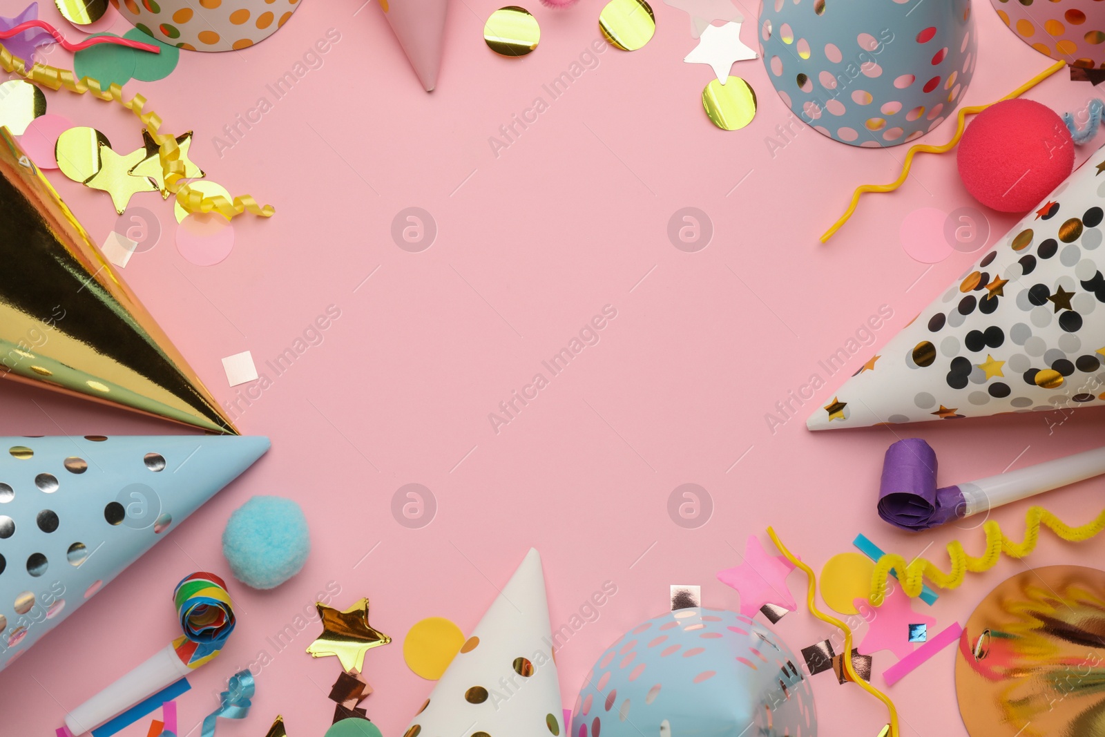 Photo of Flat lay composition with party hats and other festive items on pink background. Space for text