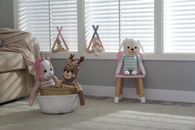 Funny toy unicorn, dog and deer in children's room.  Interior design