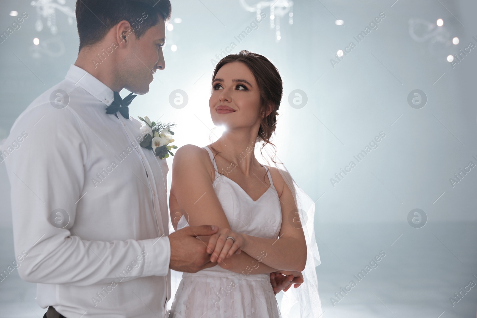 Photo of Happy newlywed couple dancing together in festive hall