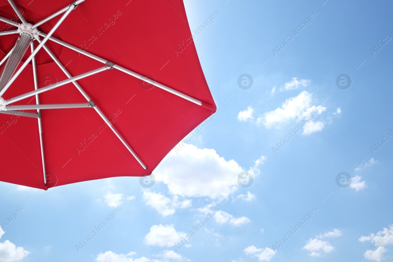Photo of View of red umbrella and blue sky on sunny day