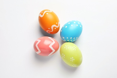 Photo of Beautiful painted Easter eggs on white background, top view