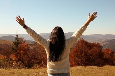 Photo of Woman in warm clothes enjoying mountain landscape