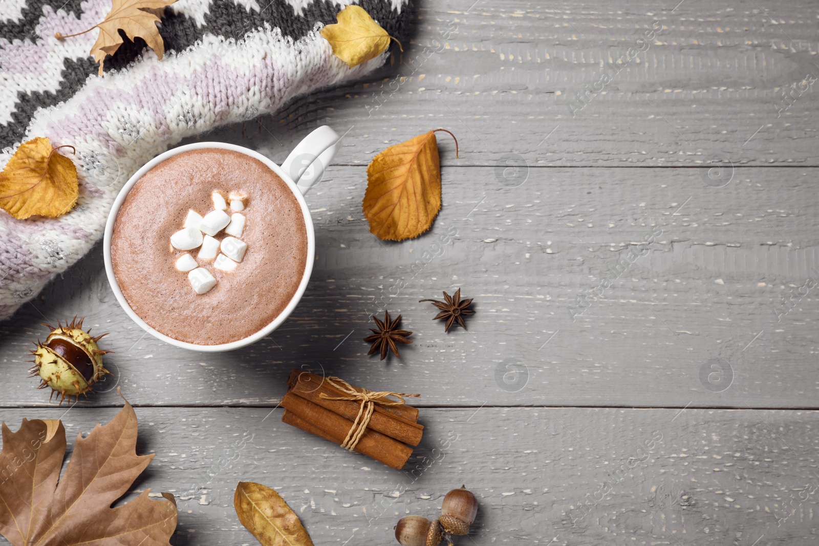 Photo of Flat lay composition with cup of hot drink on grey wooden table, space for text. Cozy autumn atmosphere