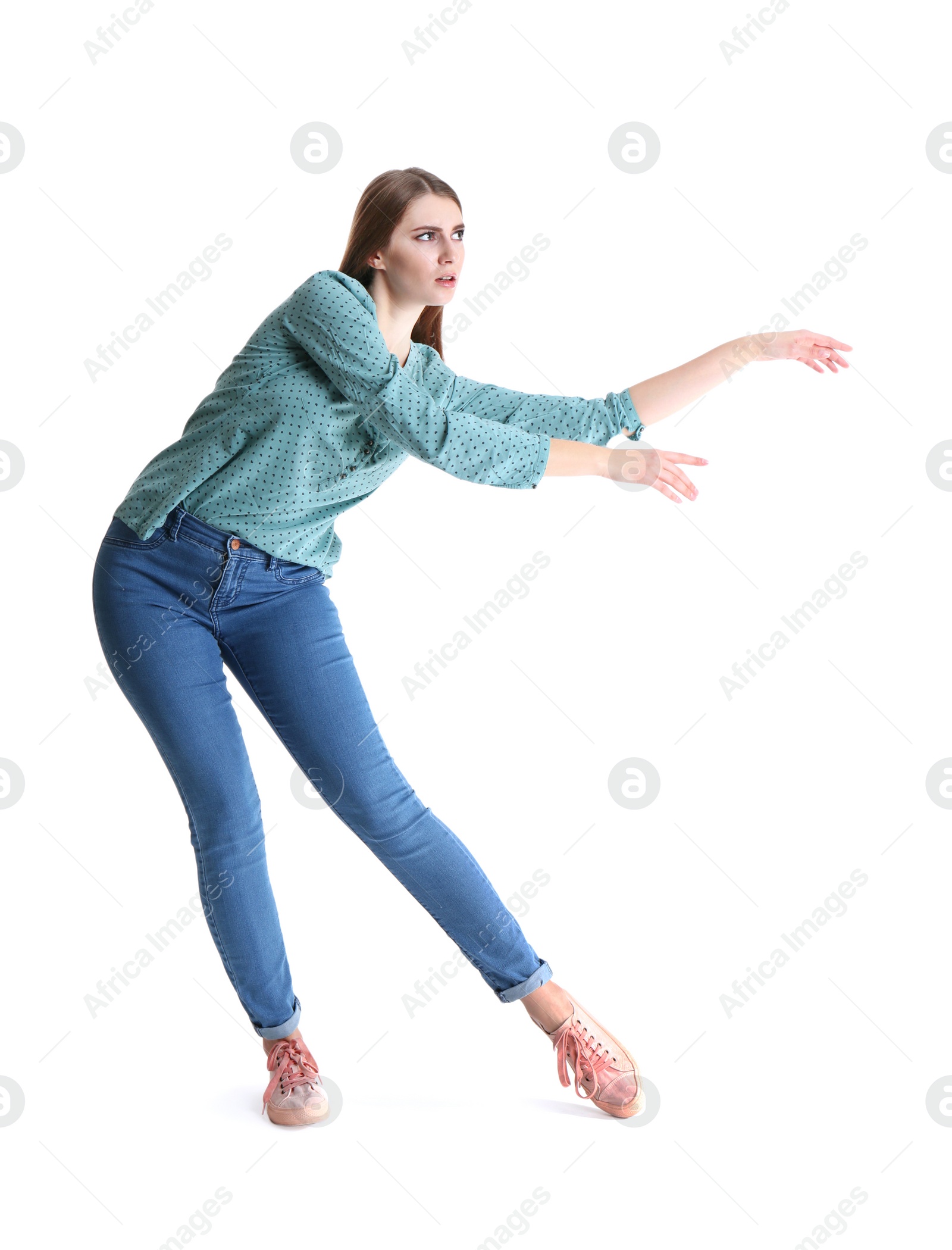 Photo of Young woman attracted to magnet on white background