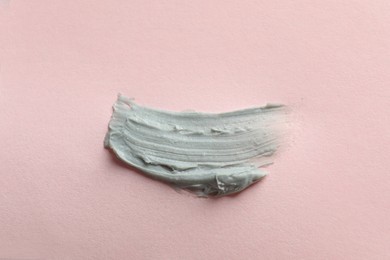 Sample of face mask on pink background, top view