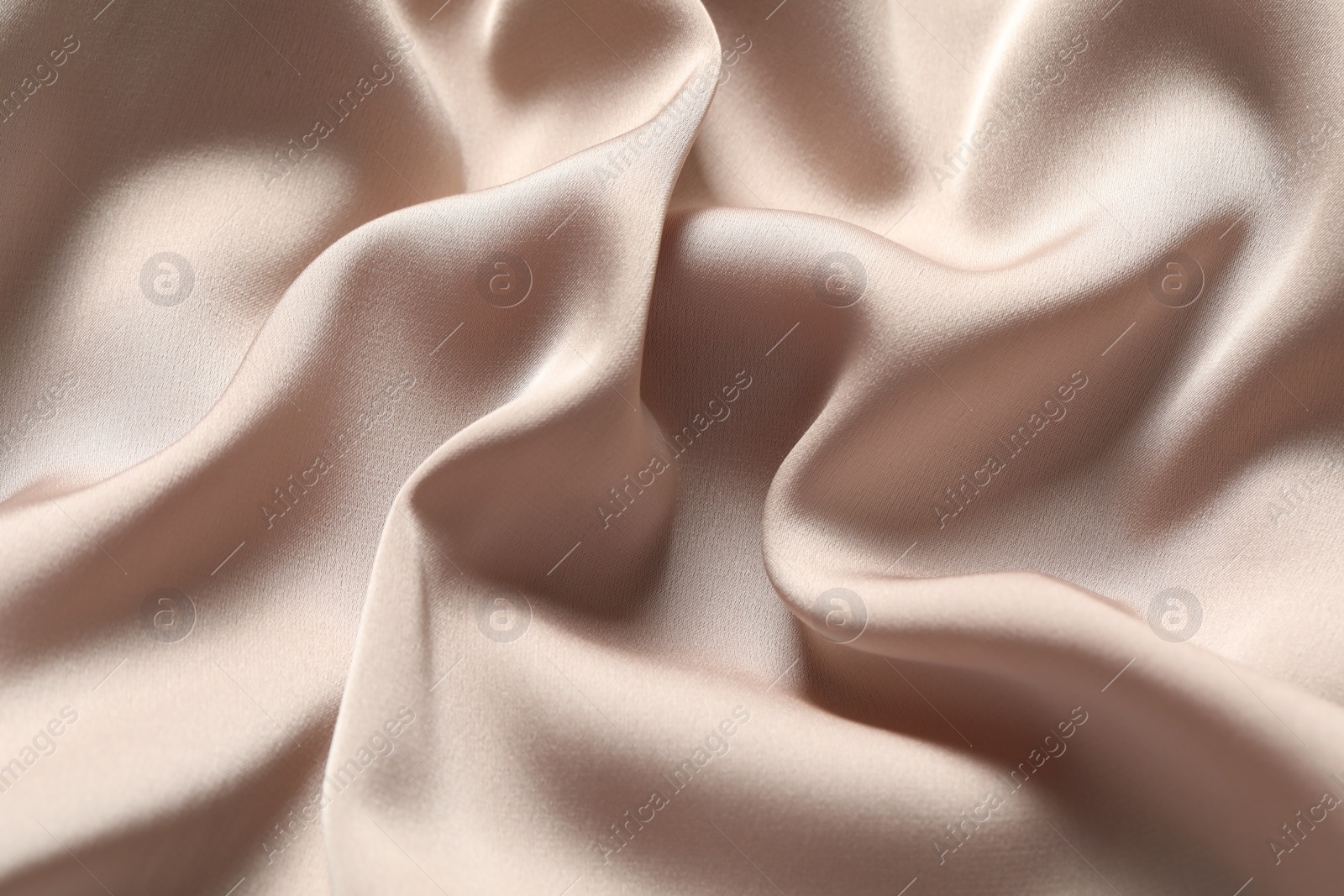 Photo of Texture of beige crumpled silk fabric as background, closeup