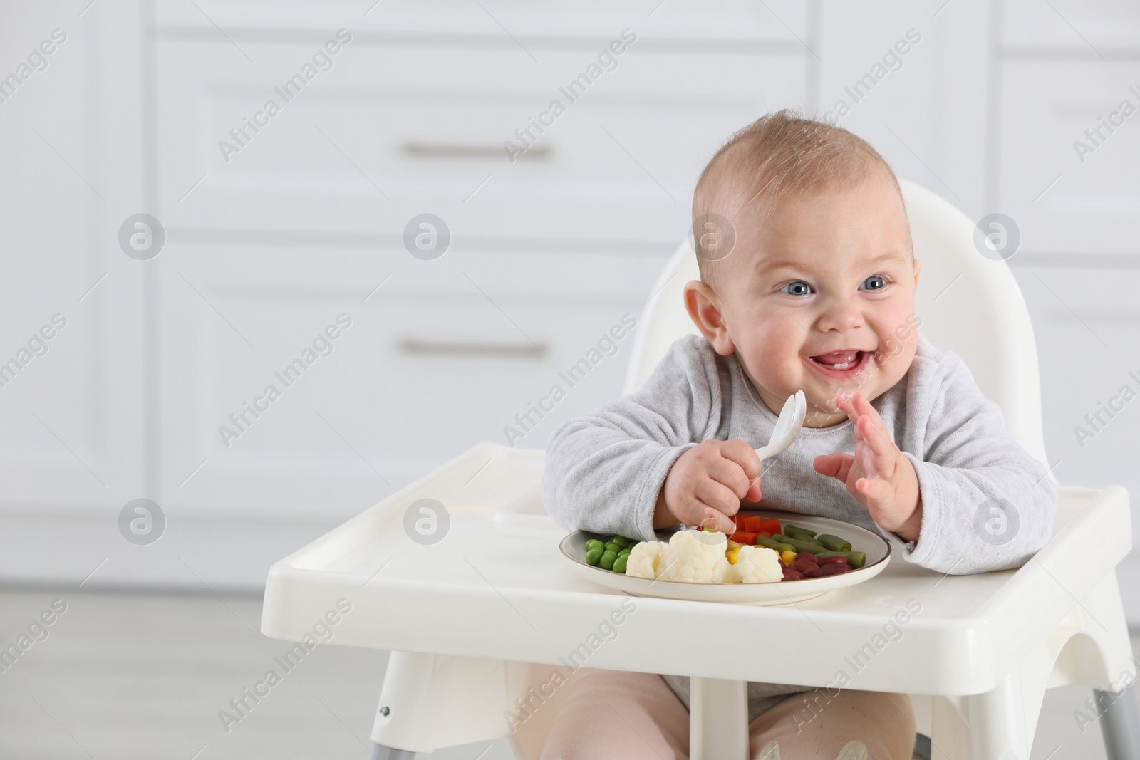 Photo of Cute little baby eating healthy food at home. Space for text