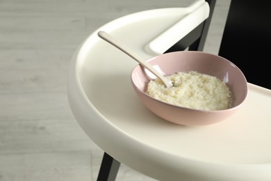 Baby high chair with healthy food, closeup view