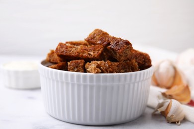 Photo of Crispy rusks with sauce on white marble table