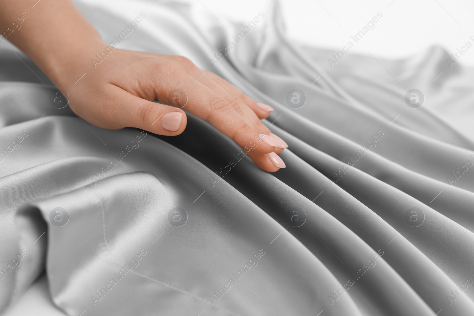 Photo of Woman touching smooth silky fabric, closeup view