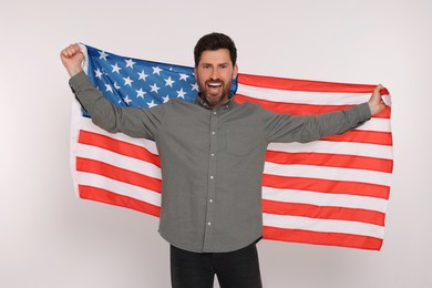 Photo of 4th of July - Independence Day of USA. Happy man with American flag on white background
