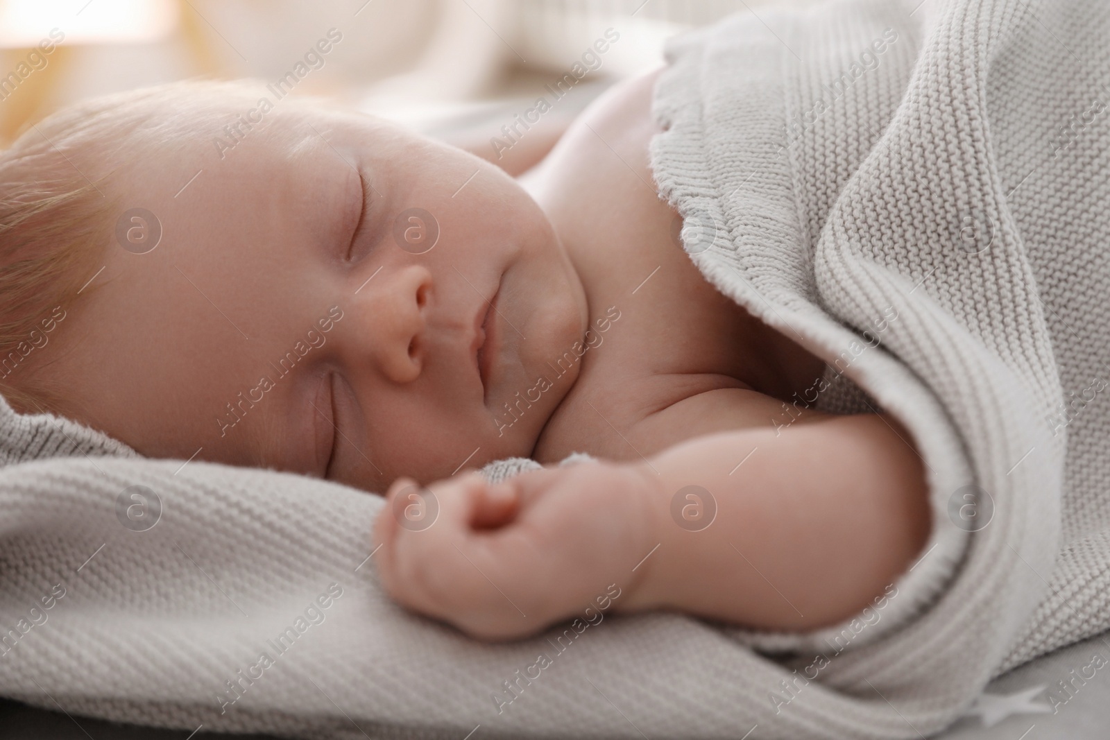 Photo of Cute little baby sleeping on bed, closeup