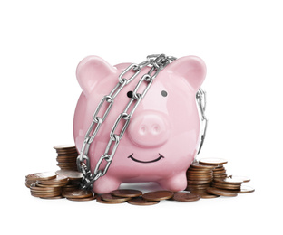 Photo of Piggy bank with steel chain and coins isolated on white. Money safety concept