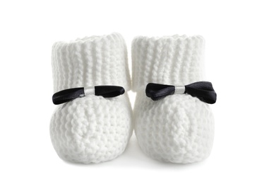 Handmade baby booties with bows isolated on white