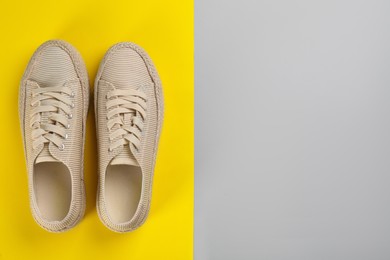 Pair of stylish sneakers on color background, flat lay. Space for text