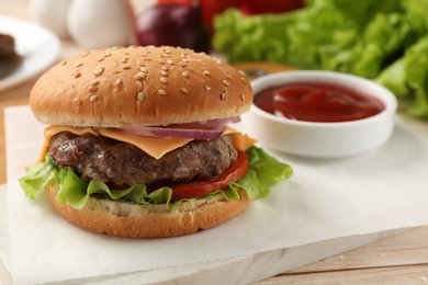Photo of Tasty hamburger with patty, cheese and vegetables on light table, closeup
