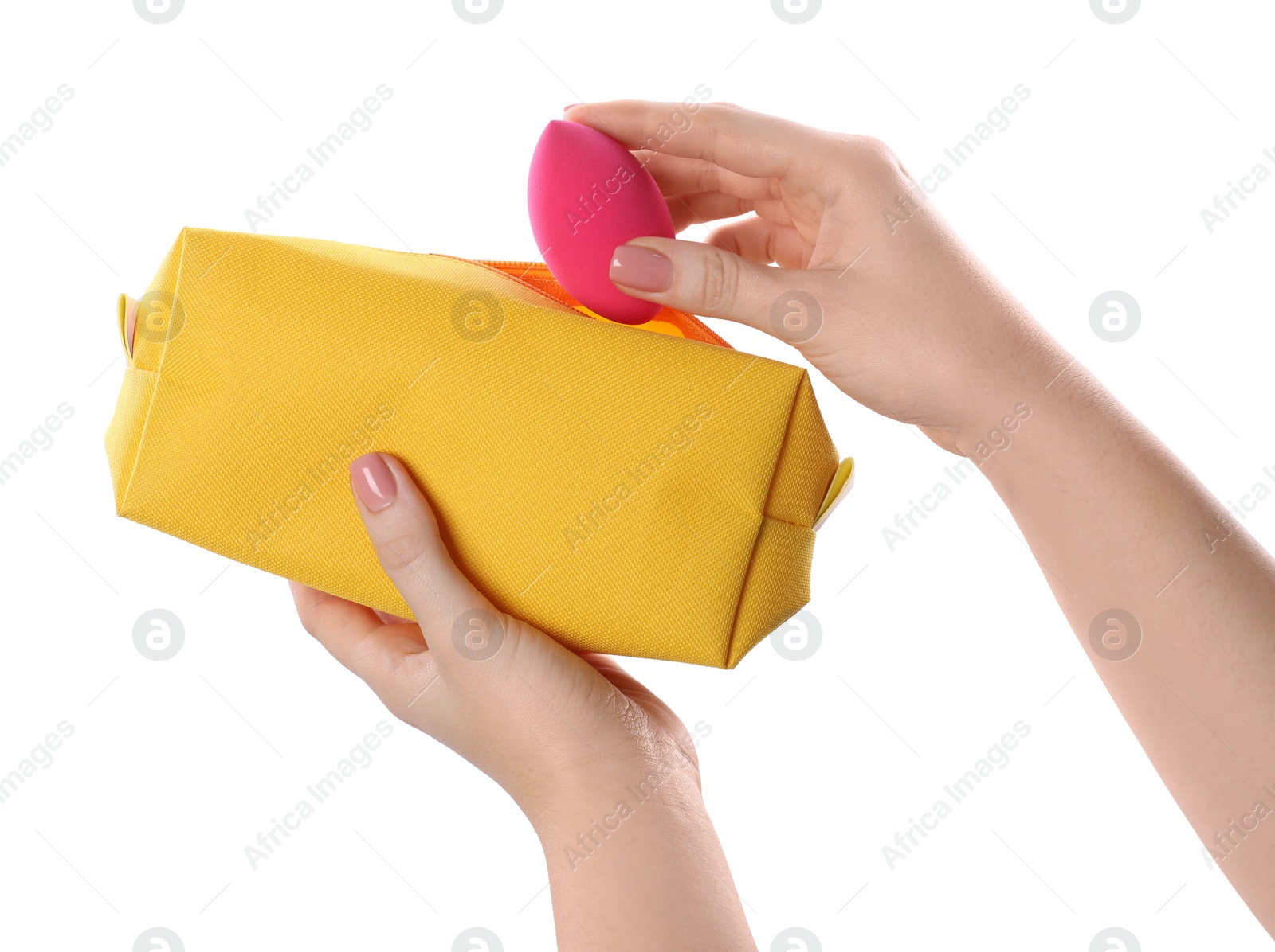 Photo of Woman putting makeup sponge into cosmetic bag on white background, closeup