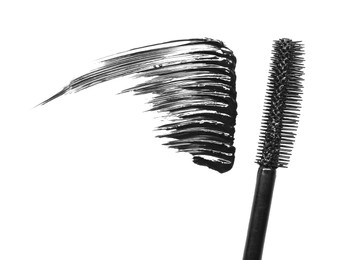 Photo of Smear of mascara and applicator isolated on white, top view