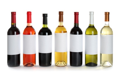 Photo of Bottles with different wine on white background