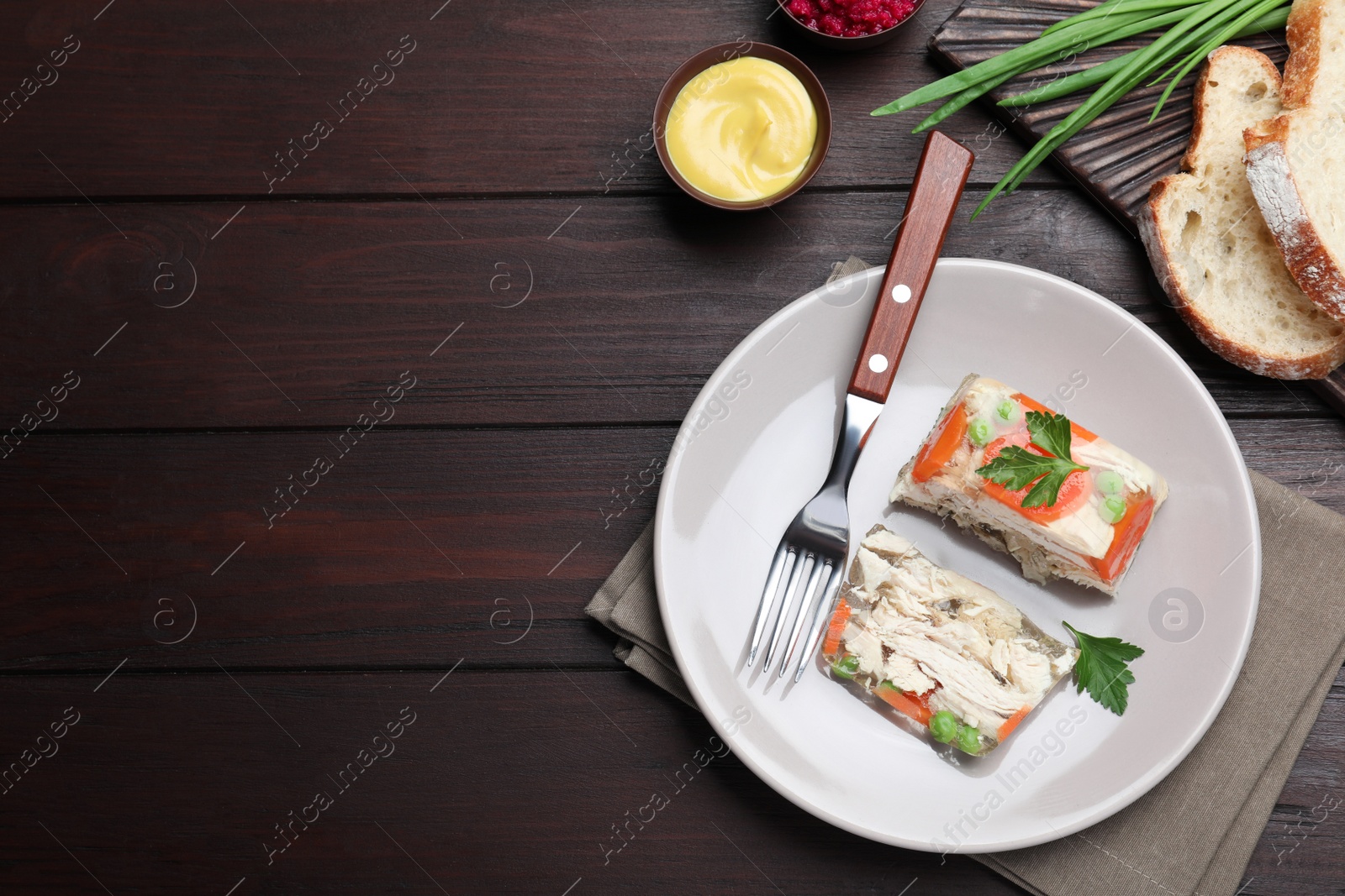 Photo of Delicious chicken aspic served on wooden table, flat lay. Space for text