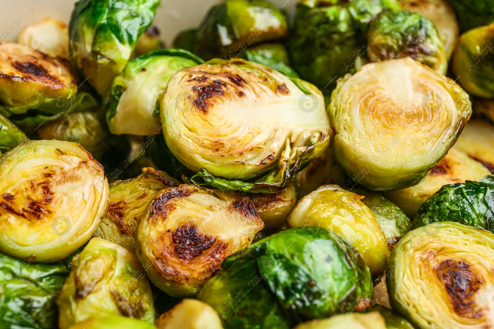 Photo of Delicious roasted Brussels sprouts as background, closeup