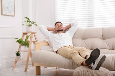 Handsome man relaxing on sofa at home