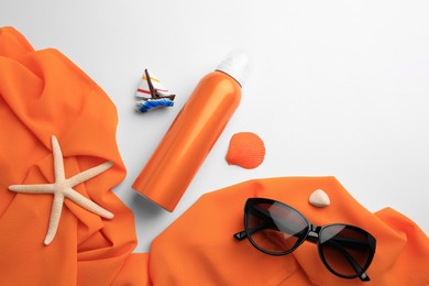 Flat lay composition with bottle of sunscreen on white background. Space for text