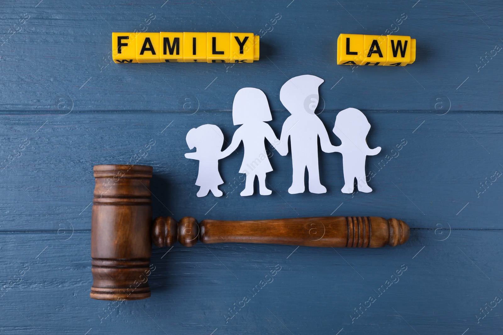 Photo of Flat lay composition with figure and gavel on blue wooden background. Family law concept