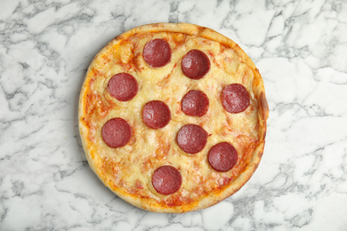 Photo of Tasty pepperoni pizza on white marble table, top view