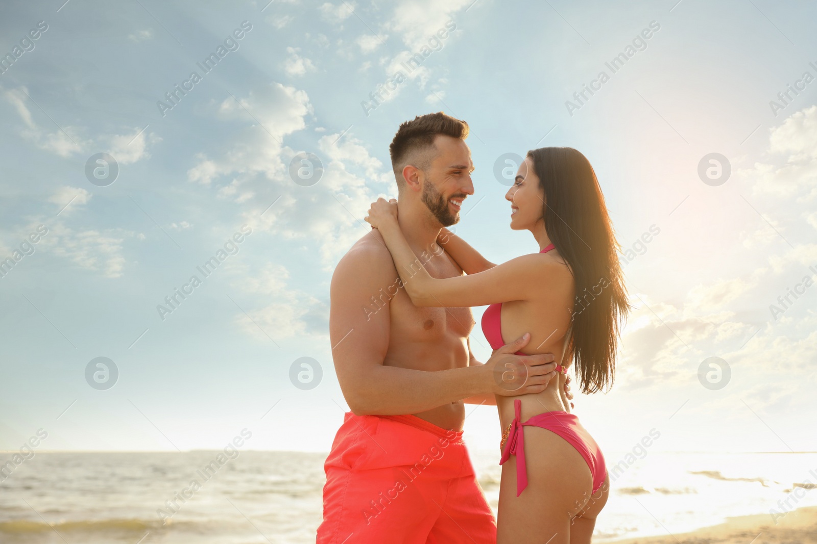 Photo of Happy young couple on beach on sunny day