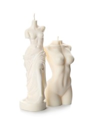 Beautiful female body shaped candles on white background