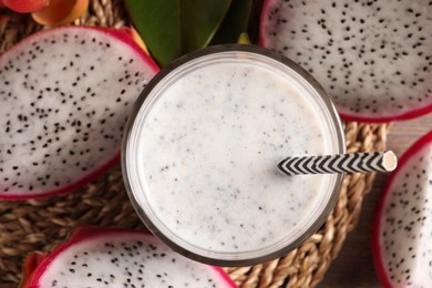 Photo of Delicious pitahaya smoothie and fresh fruits on table, flat lay