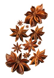 Image of Dry aromatic anise stars falling on white background