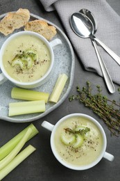 Delicious celery soup served on gray table, flat lay