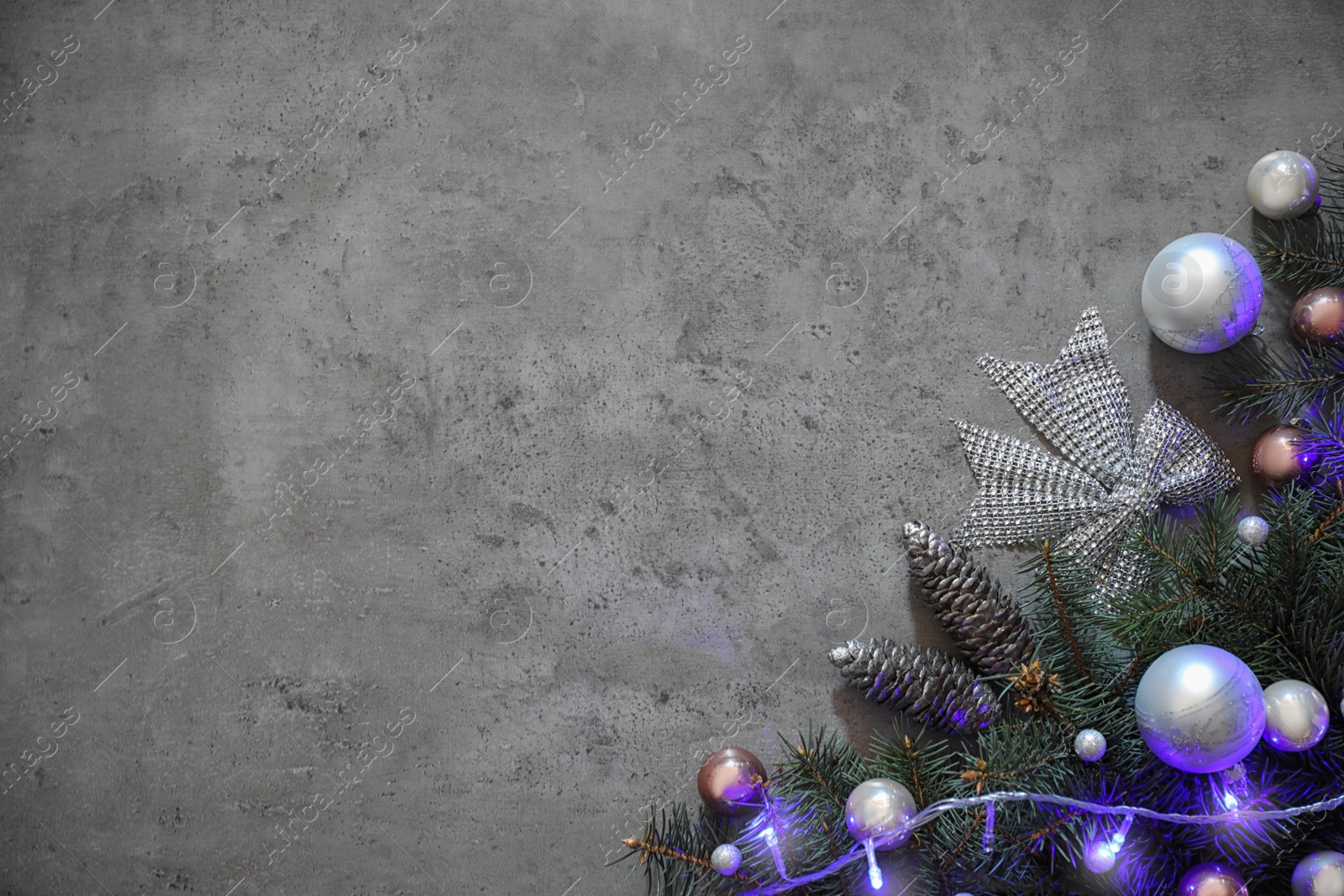 Photo of Christmas decoration on stone background, flat lay. Space for text