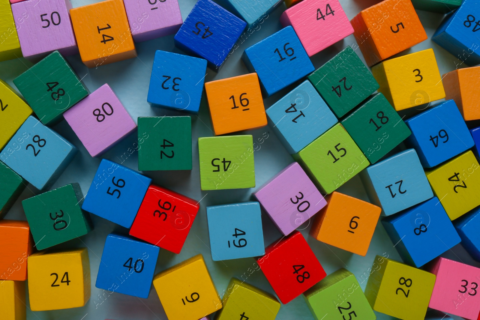 Photo of Wooden cubes with different numbers on color background, flat lay