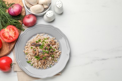 Photo of Delicious pearl barley with onion and mushrooms served on white marble table, flat lay. Space for text