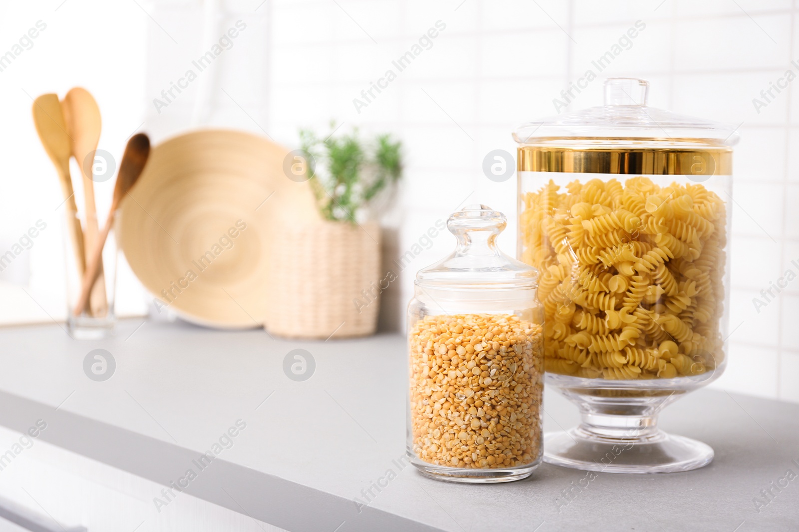 Photo of Products in modern kitchen glass containers on table. Space for text